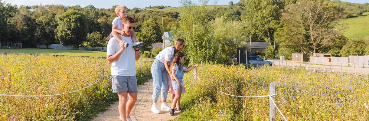 Family walking around the gardens at The Garlic Farm, Isle of Wight